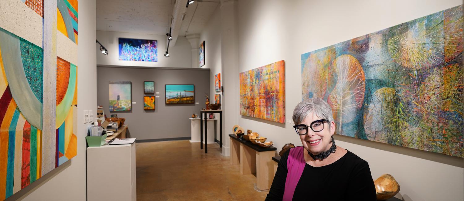 Artist Jeanne Nikolai Olivieri stands in her gallery space
