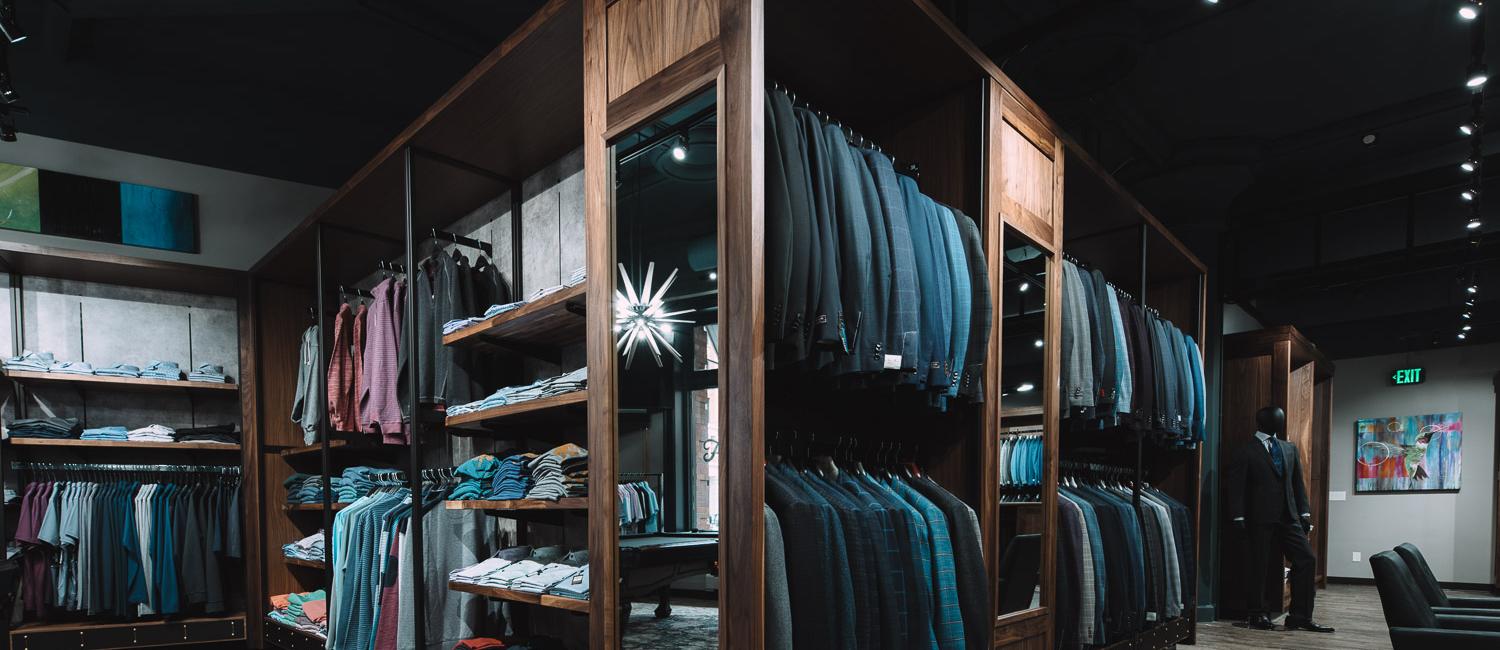 Multiple clothing racks of high-end men's apparel